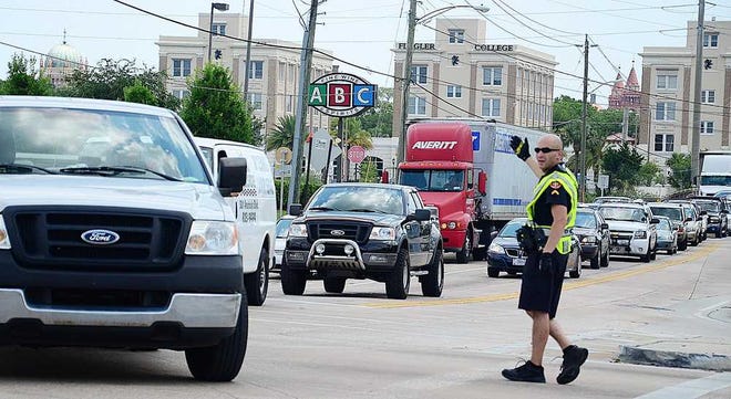 A St. Augustine police officer directs traffic in the intersection of U.S. 1 and King Street after U.S. 1 was blocked by a fallen telephone poll on Tuesday, June 5, 2012. By PETER WILLOTT, peter.willott@staugustine.com