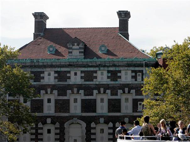This Oct. 22, 2007, file photo shows the general hospital, behind some tourists on the south side of Ellis Island in the New York harbor. Associated Press