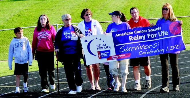 Cancer survivors and their families walk a lap during the first Teen Relay For Life event at MTHS.