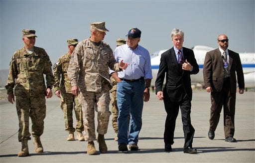 U.S. Defense Secretary Leon Panetta, center right, speaks with U.S. Ambassador to Afghanistan Ryan Crocker, second right, and the head of NATO coalition forces in Afghanistan Gen. John Allen, center left, upon his arrival at Kabul International Airport in Kabul, Afghanistan Thursday, June 7, 2012. Panetta arrived in Afghanistan on Thursday to take stock of progress in the war and discuss plans for the troop drawdown, even as violence spiked in the south. (AP Photo/Jim Watson, Pool)