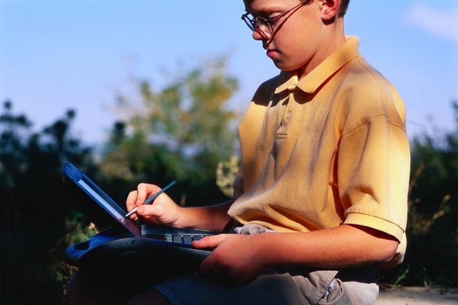 Boy Working on Laptop Computer
