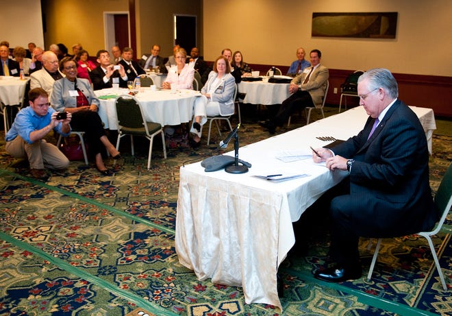 Gov. Jay Nixon signs House Bill 1042 Thursday during a higher education summit at the Courtyard by Marriott in Columbia. The measure makes it easier to transfer credits among public colleges in the state. Budget shortfalls and degree attainment were among the topics discussed at the summit.
