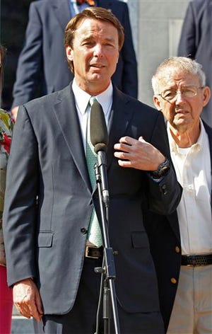 Ex-presidential candidate John Edwards speaks outside a federal courthouse as his father, Wallace Edwards, right, listen after his campaign finance fraud case ended in a mistrial Thursday, May 31, 2012 in Greensboro, N.C. Jurors acquitted Edwards on one charge and deadlocked on the other five, unable to decide whether he used money from two wealthy donors to hide his pregnant mistress while he ran for president and his wife was dying of cancer. (AP Photo/Chuck Burton)