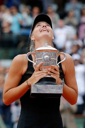 Maria Sharapova holds French Open trophy after winning the women's final match against Sara Errani, 6-3, 6-2, on Saturday at Roland Garros in Paris.