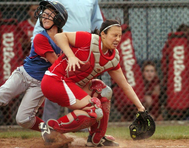 Coginchaug’s Dina Canalla scores Friday as she collides with St. Bernard catcher Shoshana Berkman during the Class S softball championship at West Haven High School. The Blue Devils won, 6-0.
