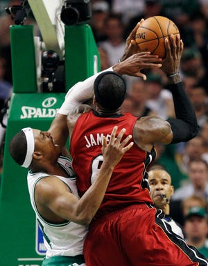 Celtics forward Paul Pierce, left, tries to defend against Heat forward LeBron James (6) during the second quarter in Game 6 of Thursday's Eastern Conference finals in Boston.