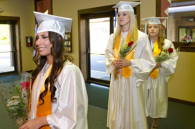 The Heritage Christian Academy class of 2012, all three of them, (L to R) Kary Hasbun of Mt. Laurel, Jordan Heller of Willingboro, and Allisa Shinn of Chatsworth, proceed to march into the school's commencement exercises in Mt. Laurel Friday night.