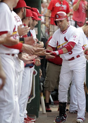 The St. Louis Cardinals' Carlos Beltran celebrates with his teammates after hitting a solo home run in the third inning of Saturday's game against Cleveland.
