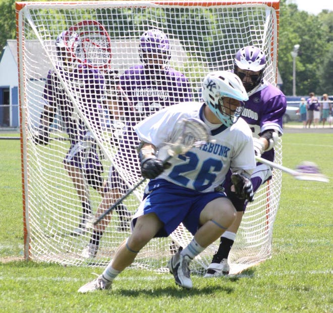 Kennebunk's Sean Foley works behind the Marshwood net during Saturday's West A semifinal at Kennebunk.