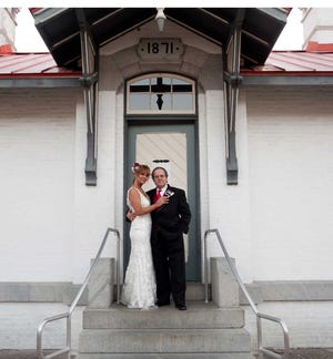 Mr. and Mrs. James Augustine Ponce Jr. pose in front of the lighthouse following their wedding April 28.
