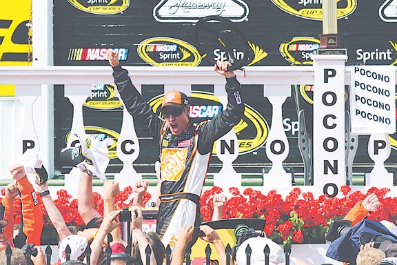 Joey Logano celebrates in victory lane after winning the NASCAR Sprint Cup Series auto race at Pocono Raceway, Sunday, June 10, 2012, in Long Pond, Pa.