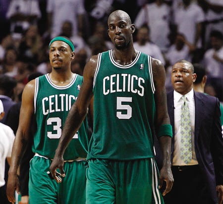 Boston Celtics center Kevin Garnett (5) and forward Paul Pierce walk up the court as coach Doc Rivers watches during the final minutes of Game 7 of their Eastern Conference finals series against the Miami Heat Saturday in Miami.