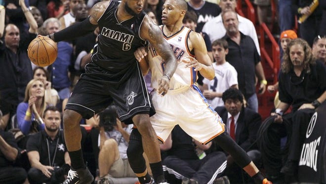 LeBron James looks for a path around Oklahoma City's Russell Westbrook during the Heat's game against the Thunder on April 4, 2012, in Miami. The teams face off again in the NBA Finals.