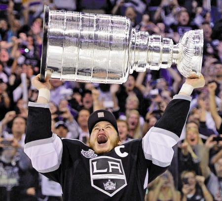 Los Angeles Kings captain Dustin Brown hoists the Stanley Cup after the Kings beat the New Jersey Devils 6-1 in Game 6 of the Stanley Cup finals on Monday in Los Angeles.