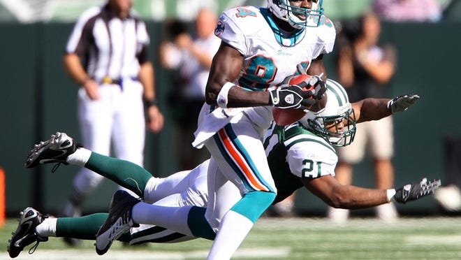 Chris Chambers, shown making a catch while with the Dolphins in a 2007 game, says he's skeptical that Chad Ochocinco will solve the team's problems at receiver.