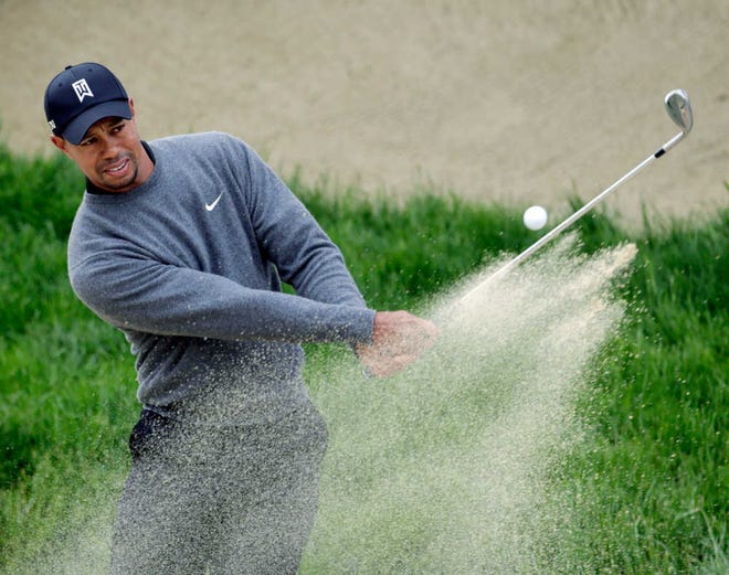 Tiger Woods hits out of a bunker on the second hole during a practice round for the U.S. Open Championship golf tournament Wednesday, June 13, 2012, at The Olympic Club in San Francisco. (AP Photo/Eric Gay)