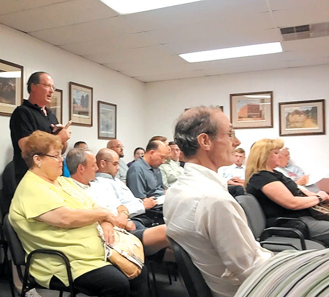 Darin Pitsnogle addresses the Antrim Township supervisors during a public hearing about rezoning residential land to highway commercial in the Hykes Road area. Many residents, including Pitsnogle, expressed concerns with the potential expansion of the JLG facility if the rezoning is approved.