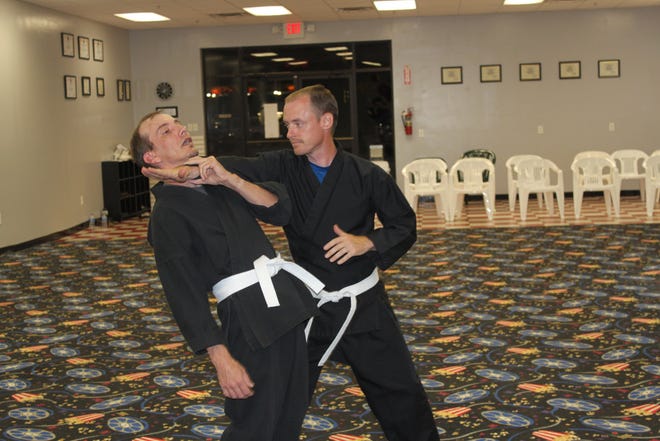 Chad McDaniel and John Huddle, white belts, demonstrate a "breakaway" technique.