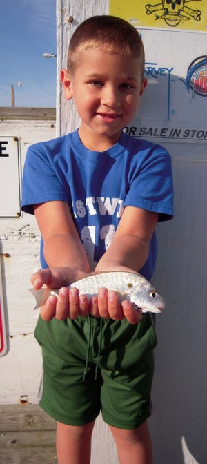 Grayson Watson with his first spot and one of the first of the season caught on the pier. Grayson caught the spot on shrimp and is from Fleetwood, NC, age 7. Photo courtesy Oak Island Pier