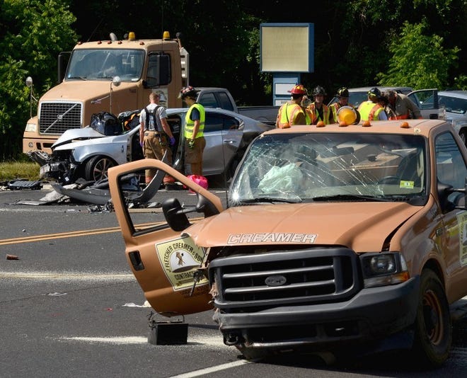Nancy Rokos/Staff Photographer/ 
 Mansfield Township emergency personnel on the scene of an accident involving three vehicles on Route 206 across from the Bella Mia Italian Restaurant, Thursday afternoon. Traffic was detoured going northbound.