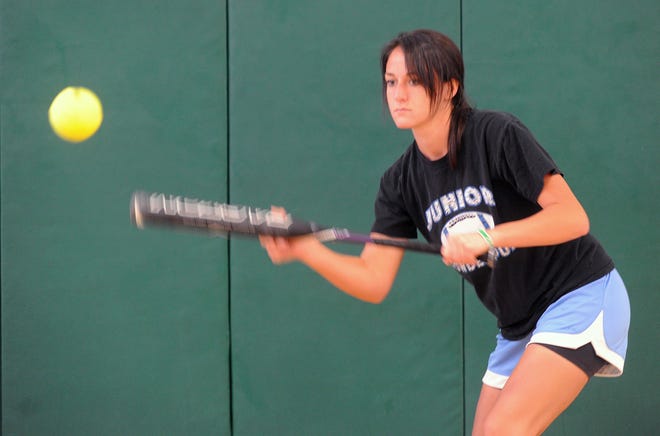 Jill Marella practices her bunts during a workout in the Green Wave's gym on Tuesday.