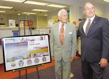 Sal Zona, a veteran and longtime barber at Pease International Tradeport, and his friend, Richard Martell, retired commander of the 157th Air Refueling Wing at Pease Air National Guard Base, display a collection of aviation images Zona is donating to Service Credit Union.