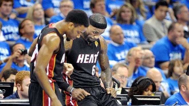 Norris Cole and LeBron James take a needed breather during a timeout.