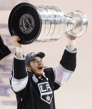Kings captain Dustin Brown holds up the Stanley Cup after the Kings beat the New Jersey Devils, 6-1, during Game 6 of the Stanley Cup finals on Monday in Los Angeles.