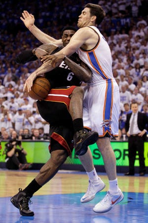 Oklahoma City Thunder forward Nick Collison fouls Miami Heat forward LeBron James Thursday during the second half of Game 2 of the NBA Finals.