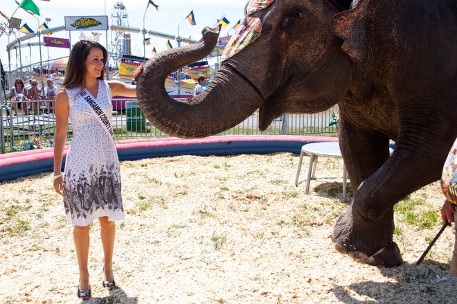 Natalie Foss, left, the 2012 Sangamon County Fair Queen, visits with one of the star attractions of the Elephant Encounter at the Sangamon County Fair in New Berlin, Ill., Friday, June 15, 2012. Justin L. Fowler/The State Journal-Register