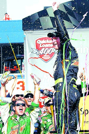 Dale Earnhardt Jr. celebrates after snapping a 143-winless drought by winning the NASCAR Sprint Cup Series race at Michigan International Speedway.