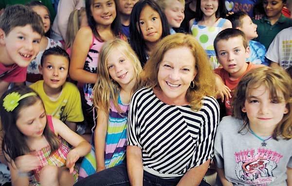 Principal Joan Ostrowski with students of Swasey Central School in Brentwood on the last day of school. Ostrowski retires from her position after twelve years.