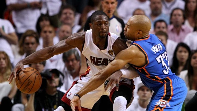 Dwyane Wade and Thunder guard Derek Fisher square off in game three of the NBA Finals at AmericanAirlines Arena in Miami on Sunday.