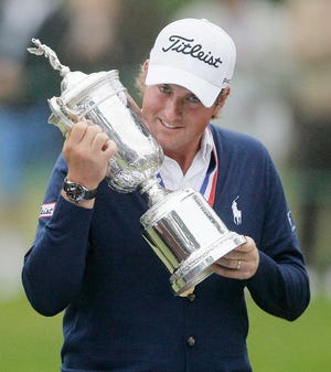 Webb Simpson kisses the trophy after winning the U.S. Open Sunday at The Olympic Club in San Francisco.