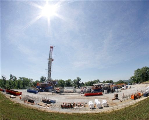 The sun shines over a Range Resources well site in Washington, Pa., in July 2011. The company is one of many drilling into the Marcellus shale layer deep underground and "fracking" the area to release natural gas.