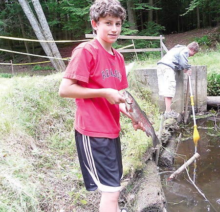 Overall winner Kyle Filion, 13, shows the 17.4-inch rainbow trout he caught.