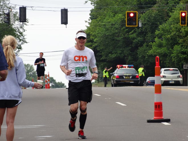 • Jason Cobb in the home stretch during the Canton Marathon on Sunday.