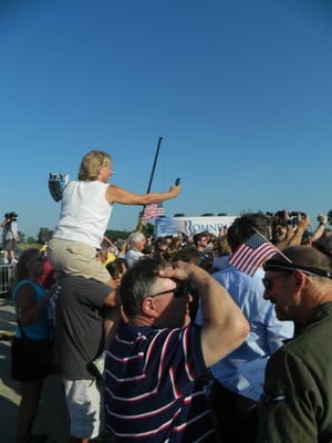 One Mitt Romney supporter sits on the shoulders of another to get a picture of the Republican presidential candidate. Andrea Goodell/Sentinel Staff