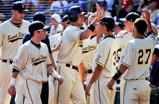 Kent State's Jason Bagoly, center, is congratulated by teammates after he scored against Florida on a single by Jimmy Rider in the second inning of an NCAA College World Series elimination baseball game in Omaha, Neb., Monday, June 18, 2012. (AP Photo/Eric Francis)