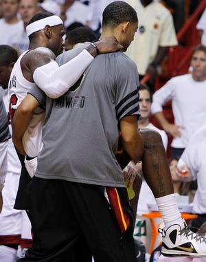 Miami's LeBron James is carried from the floor after taking a spill against the Oklahoma City Thunder during the second half of Game 4 of the NBA Finals.