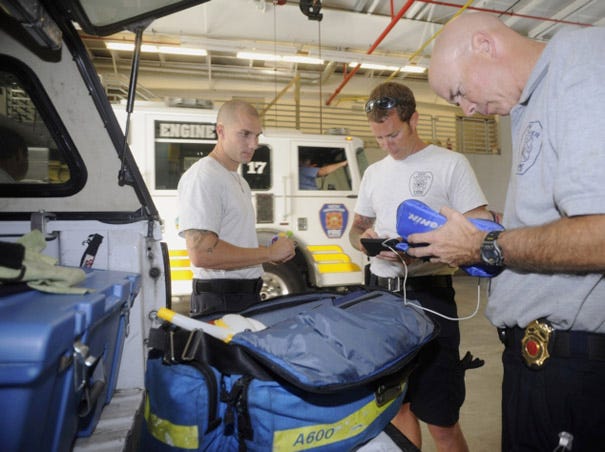 New Hanover County Firefighters Jordan Nail (from left), Scott Brown and Captain David Heath do a daily inspection on their engine's medical emergency equipment