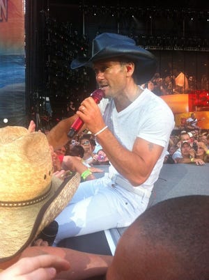 Tim McGraw charms the crowd. Not pictured: Michelle fainting in ecstasy.