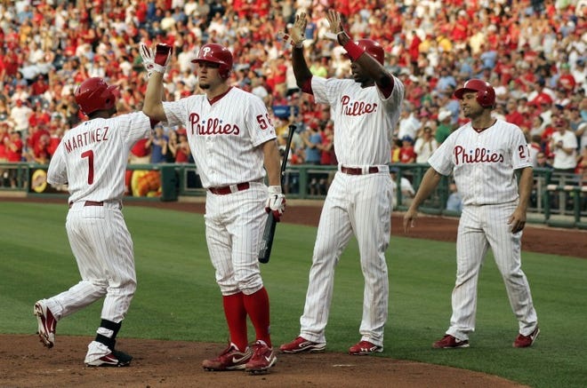Philadelphia's Michael Martinez (7) high-fives Joe Blanton after his three-run home run that scored John Mayberry (second from right) and Placido Polanco in the second inning against Colorado Rockies on Wednesday.