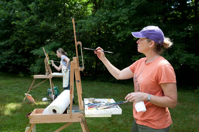 Sue Hoy, foreground, and Christine Schoettle, both of Milton, work on oil paintings outside the Forbes House Museum during the museum's Paint Out and Wet Paint Sale on Saturday morning.