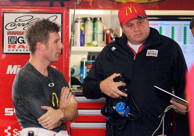 Jamie McMurray, left, talks with his team after Friday's practice for Sunday's Sprint Cup Series race in Sonoma, Calif.