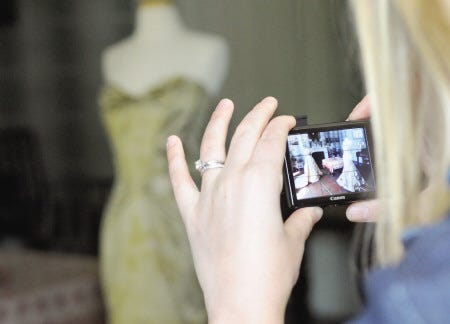 A woman takes a photo of the front formal parlor at the Goodwin Mansion where a wedding dress worn by Mable Storer Decatur (Governor Goodwin's granddaughter) which is next to a contemporary designer's creation as part of “Thread,” the new exhibit on fashion at Strawbery Banke.
Deb Cram photo