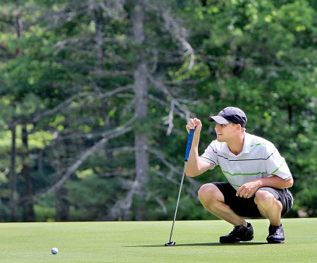 North Hampton native Michael Mahan lines up a putt during the second round of the Seacoast Amateur Golf Championship at Cochecho Country Club in Dover on Saturday. Mahan, looking for his first victory in this event, enters today’s final round with a three-shot lead.