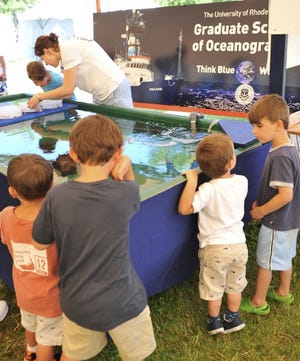 Children gather around the URI graduate school of oceanography live tank to learn about marine life in Narragansett Bay Saturday at the Exploration Zone at Fort Adams.