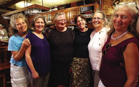 Friends, from left, Abigail Brewster, of Kittery, Maine, Sheila Pilkenton of Kittery, Fran Nutter-Upham of Nashua, Kate Hanson of Eliot, Maine, Lyn Voss of Kittery Point, and Penelope Brewster of York, Maine, pose for a picture Sunday during a celebration of Lynn Harnett's life at the Press Room in Portsmouth.