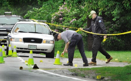 In this file photo from June 2009 Rye Police Sgt. Scott Blaisdell left and Officer Randal Tompkins investigate the scene of a drive-by house shooting on Central Road in Rye.